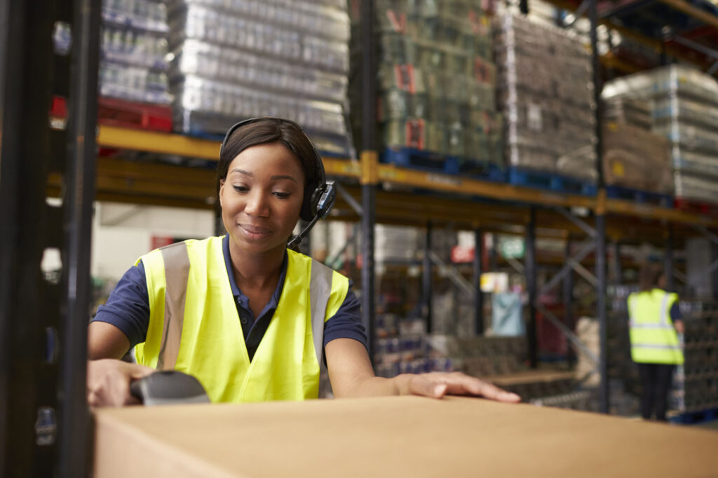 Woman using a barcode reader in a distribution warehouse